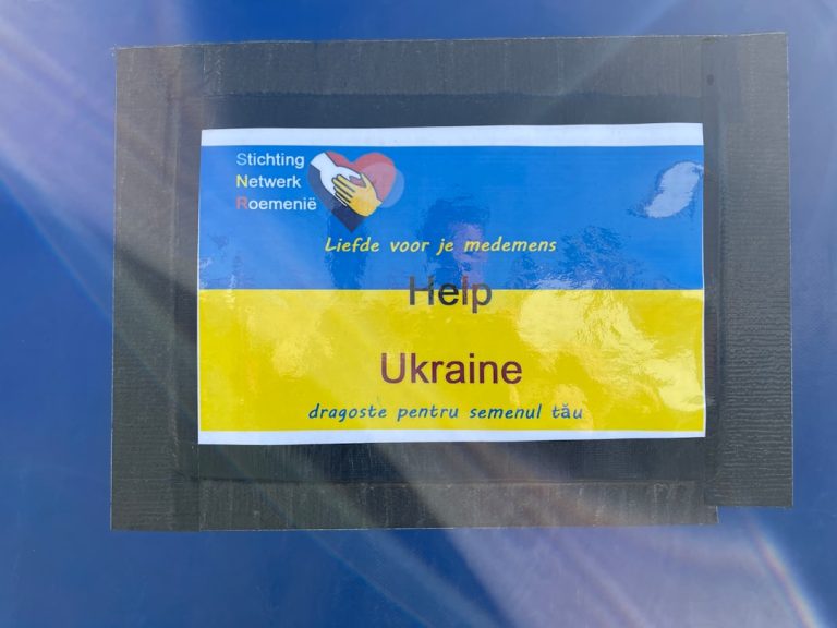 a sticker on the side of a blue car