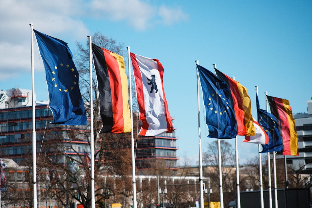 Flags of various countries are waving in the wind.