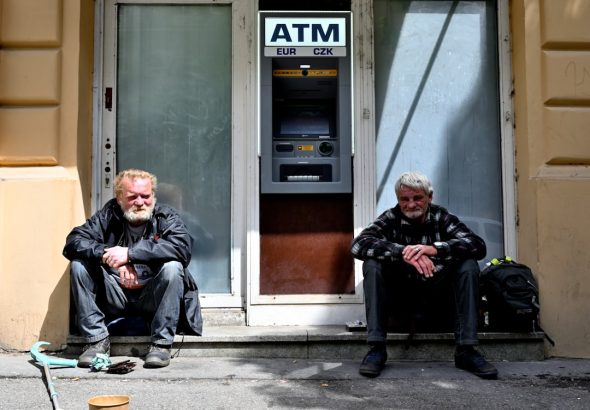 man in black jacket sitting beside man in black jacket
