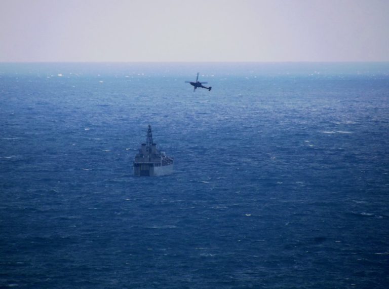 a plane flying over a large body of water
