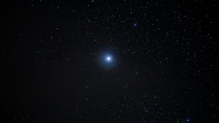 Bright star shining in the dark night sky.