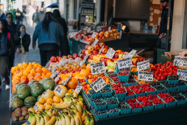 Fresh fruit and berries displayed at a market stall.