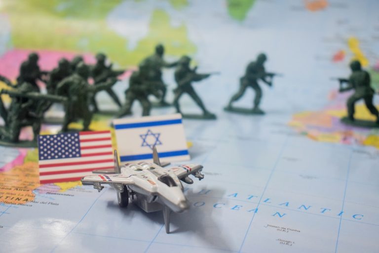 Toy soldiers, flags, and jet on world map.