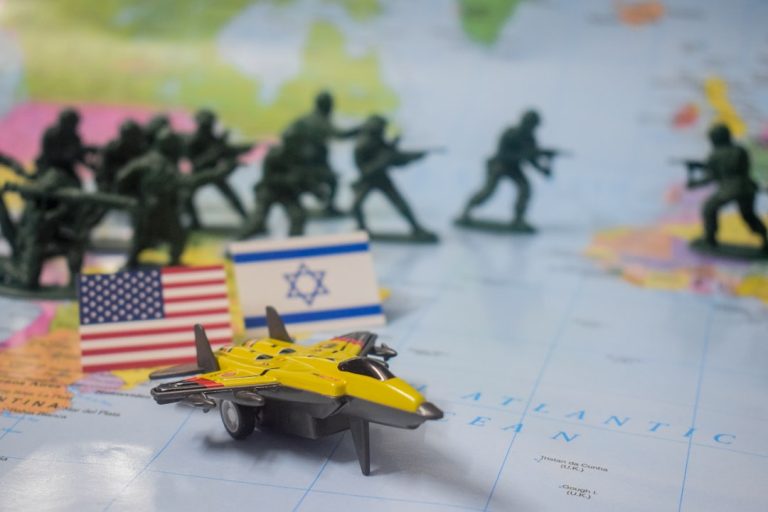 Toy soldiers and jet on map with flags