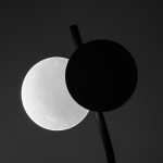 Two circles, one white and one black, on dark background