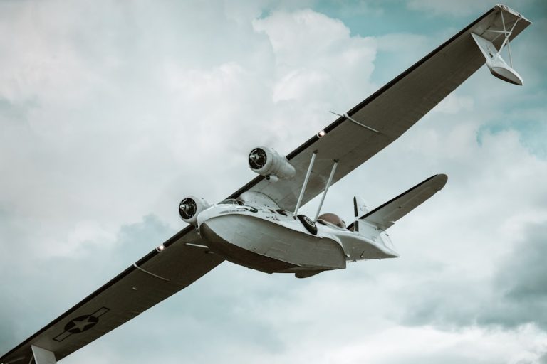 a small airplane flying through a cloudy sky