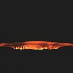 photography of people near cave at night time